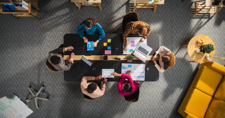 Startup,Meeting,Room:,Team,Of,Entrepreneurs,Sitting,Around,Conference,Table,
